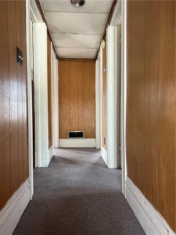 a kitchen with a refrigerator and a stove top oven