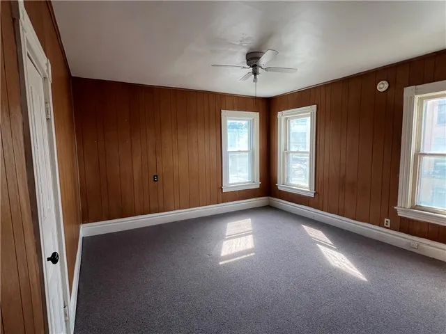 a view of a livingroom with a ceiling fan and window