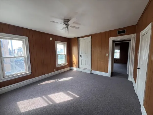 a view of a livingroom with a ceiling fan and window