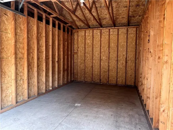 a view of a porch with wooden walls