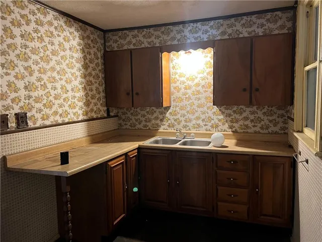 a kitchen with a sink and cabinets