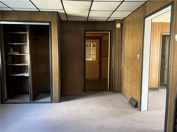 an empty room with closet and windows