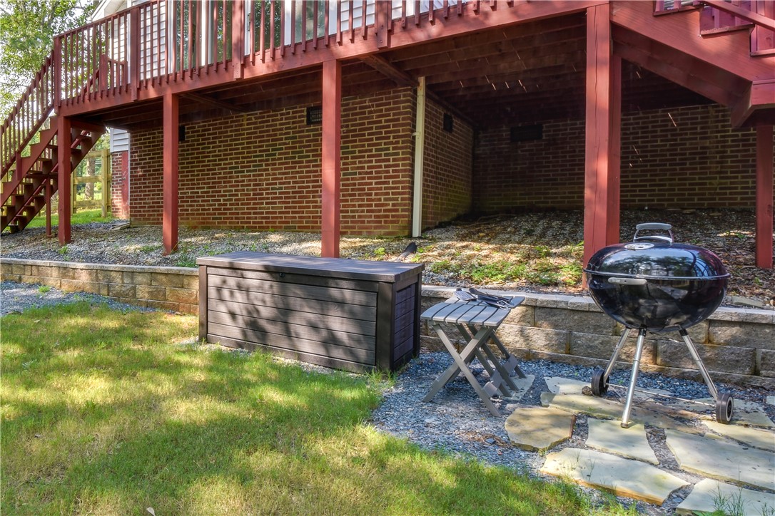206 Petty Road Seneca, SC 29672 - Photo 2 of 48 A vibrant backyard space perfect for outdoor entertaining, featuring a lower-level brick exterior and a spacious deck above.