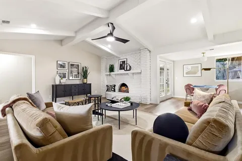a living room with furniture and a chandelier