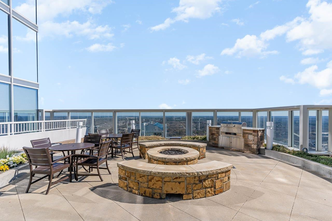 301 Fayetteville Street, Unit 2305 Raleigh, NC 27601 - Photo 13 of 23 a view of roof deck with table and chairs potted plants with sky view