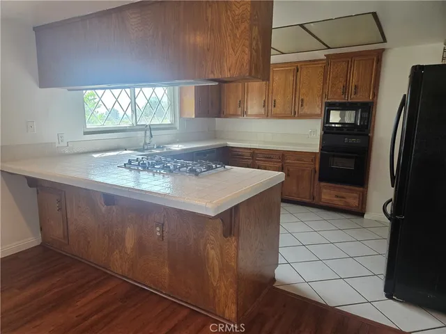 a kitchen with stainless steel appliances a sink stove and refrigerator