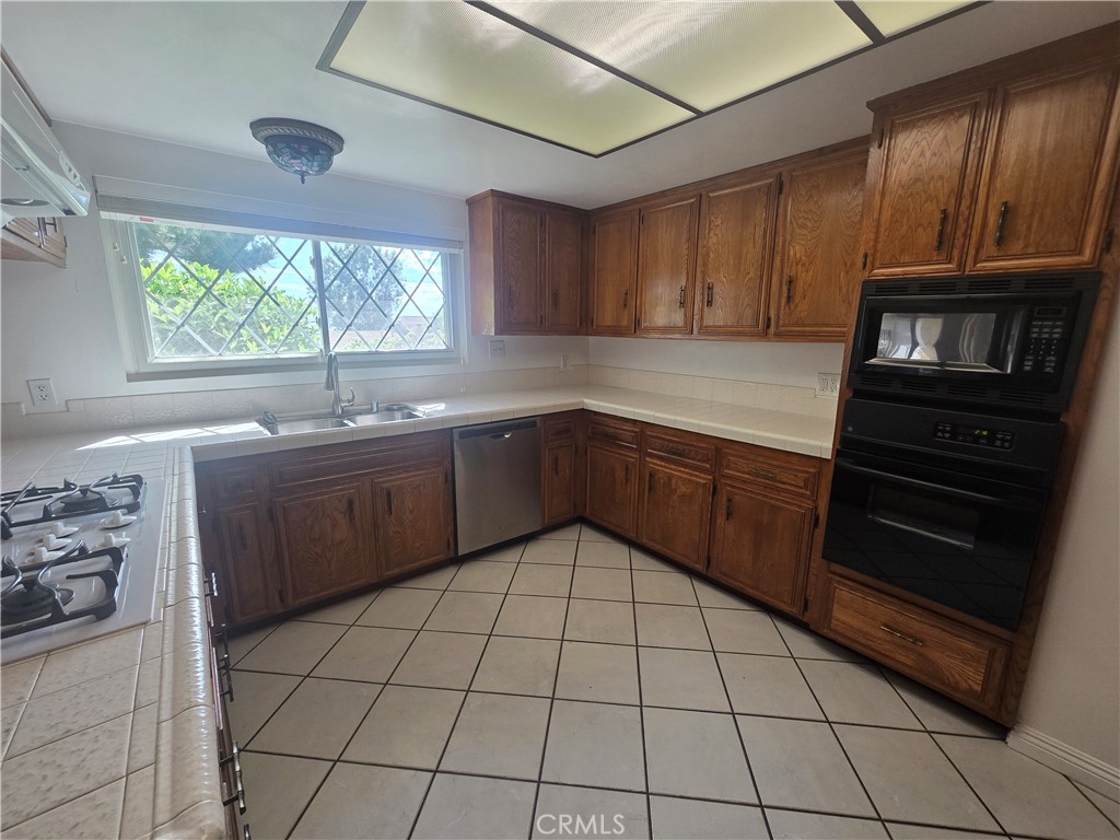 9388 Valley View Street Rancho Cucamonga, CA 91737 - Photo 12 of 40 a kitchen with a sink and cabinets