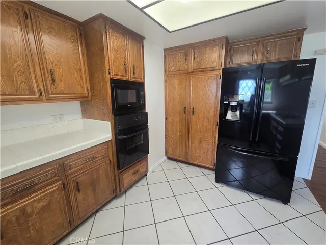 a kitchen with granite countertop stainless steel appliances and cabinets
