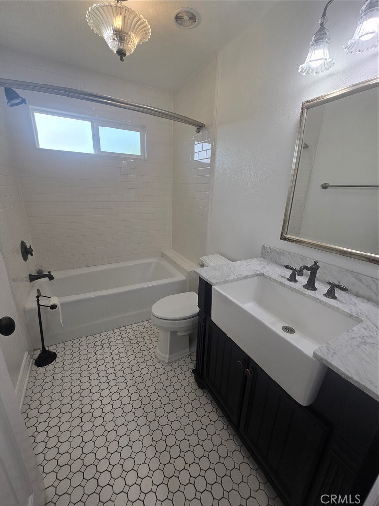 9388 Valley View Street Rancho Cucamonga, CA 91737 - Photo 20 of 40 a bathroom with a sink a toilet and shower