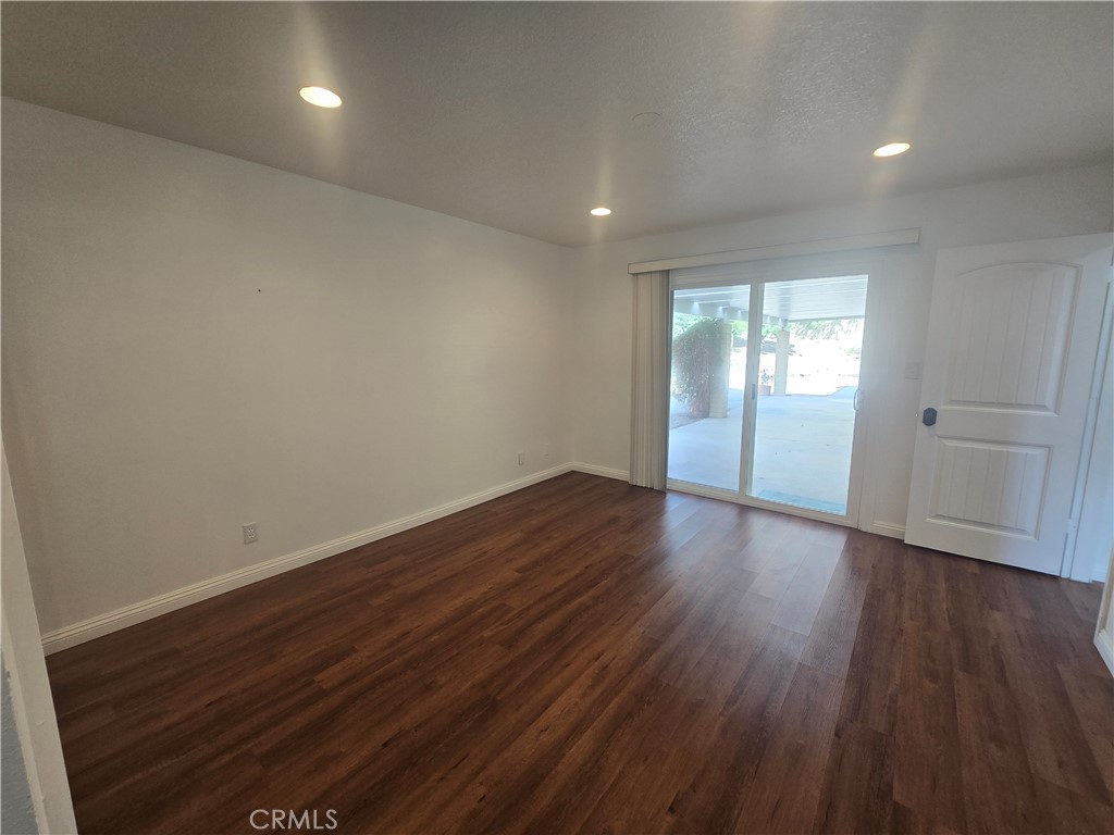 9388 Valley View Street Rancho Cucamonga, CA 91737 - Photo 30 of 40 a view of empty room with wooden floor and fan
