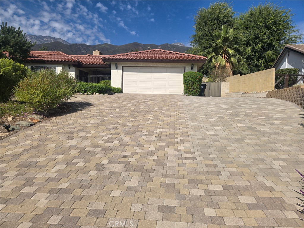9388 Valley View Street Rancho Cucamonga, CA 91737 - Photo 3 of 40 a view of a white house with a yard