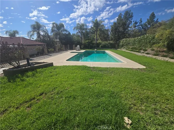 a view of a backyard with swimming pool