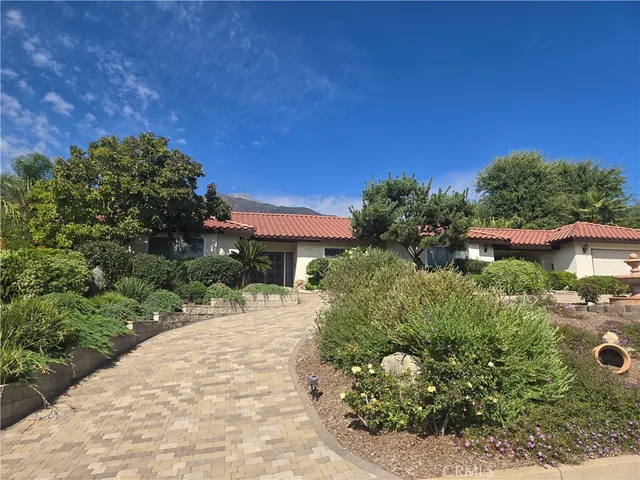 a view of a garden with a house