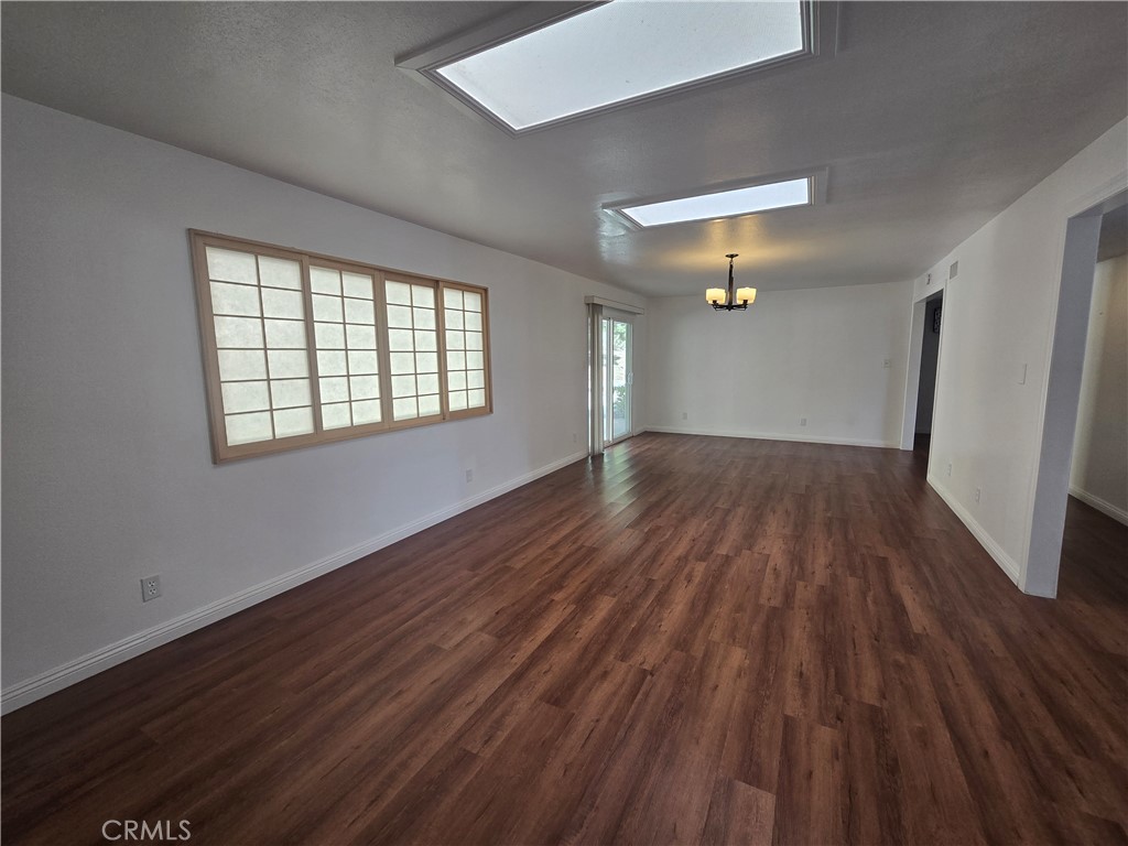 9388 Valley View Street Rancho Cucamonga, CA 91737 - Photo 7 of 40 an empty room with wooden floor and windows