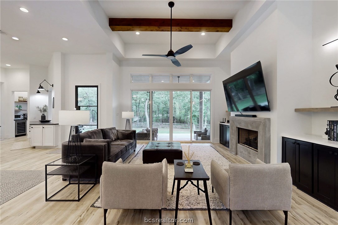 1629 Sawmill Road Franklin, TX 77856 - Photo 11 of 47 a living room with furniture a flat screen tv and a fireplace