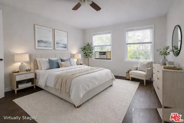 a bedroom with a bed couch and window