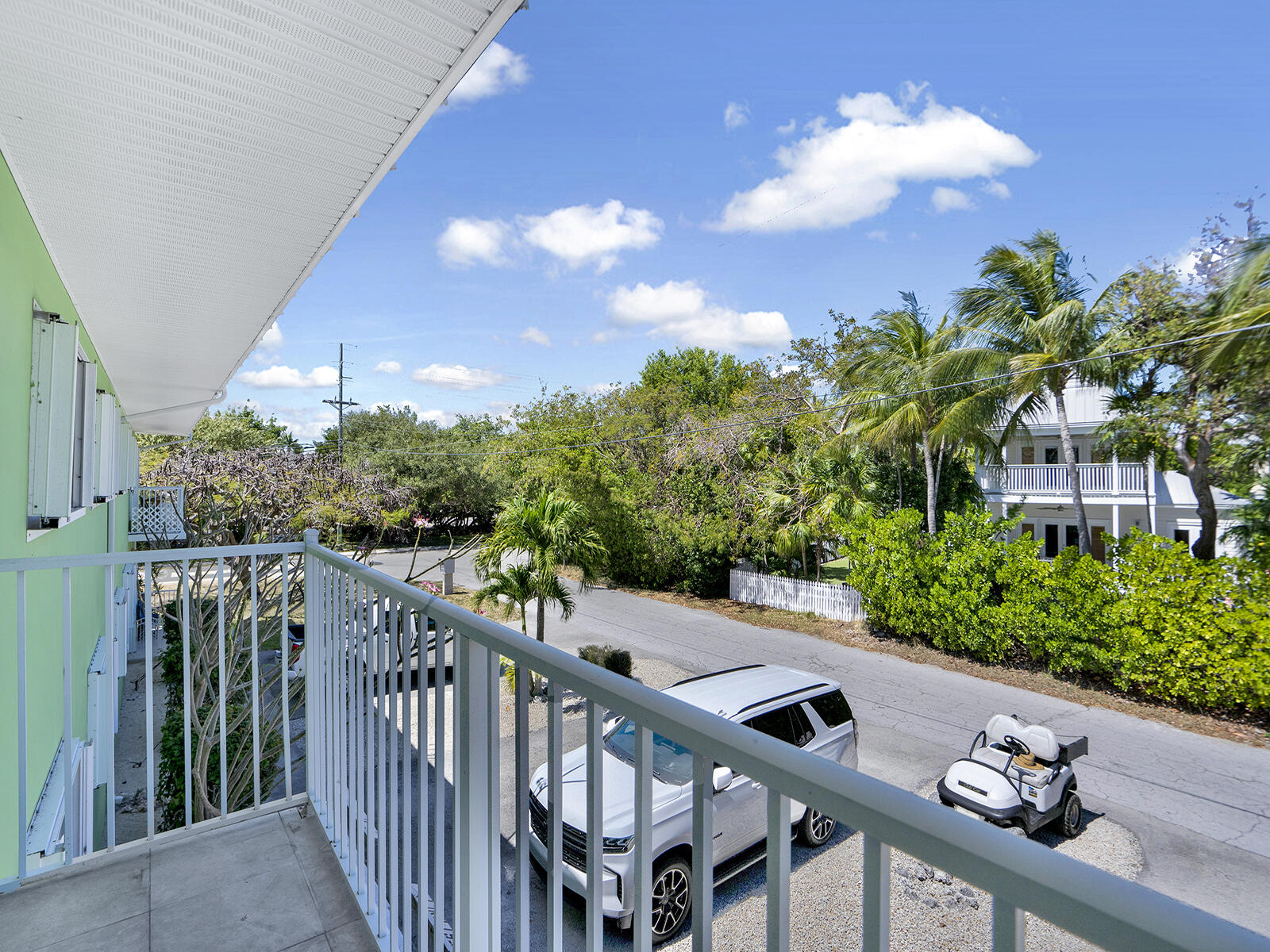 1129 Pebble Beach Lane, Unit 11 Marathon, FL 33050 - Photo 20 of 36 a view of a balcony with chairs and wooden fence