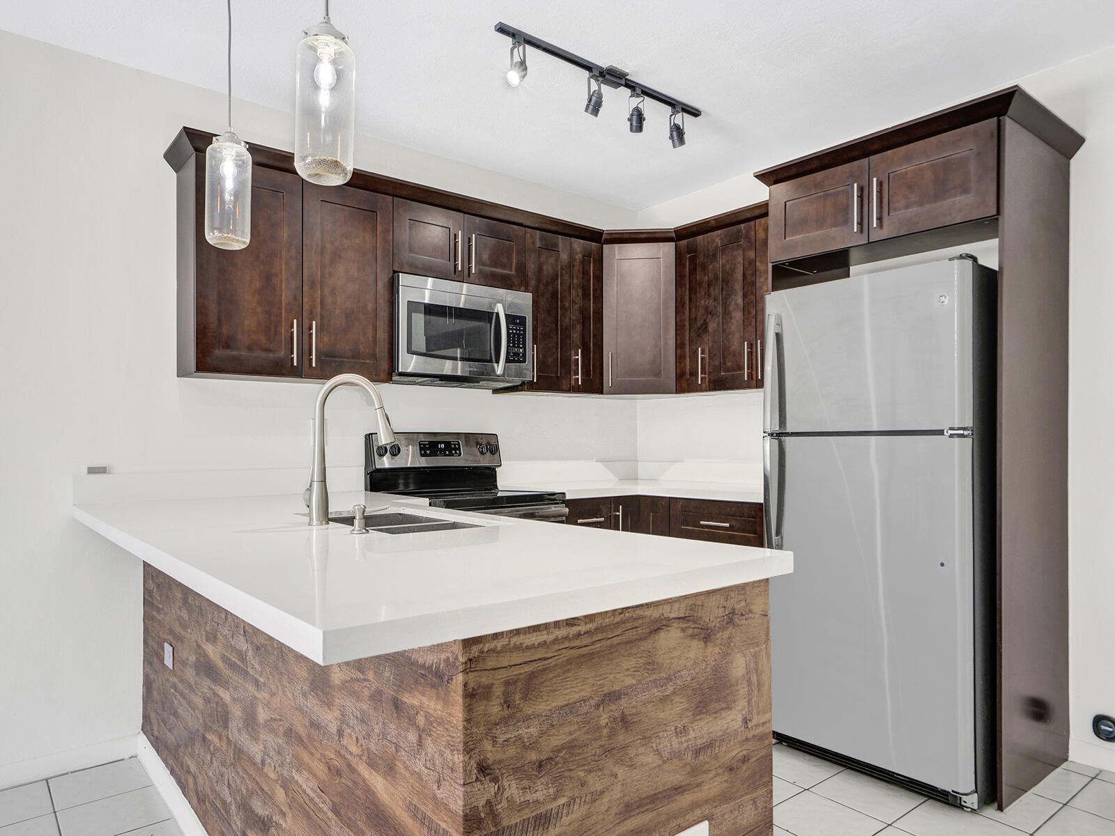 1129 Pebble Beach Lane, Unit 11 Marathon, FL 33050 - Photo 3 of 36 a kitchen with stainless steel appliances a refrigerator stove microwave and sink