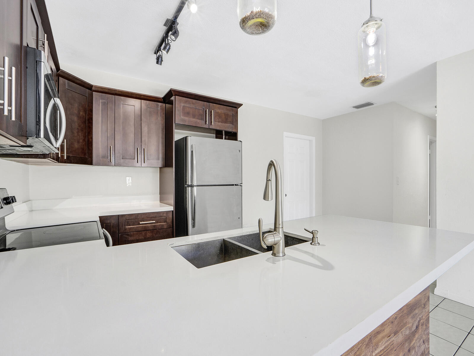 1129 Pebble Beach Lane, Unit 11 Marathon, FL 33050 - Photo 5 of 36 a bathroom with a sink a large mirror and a shower