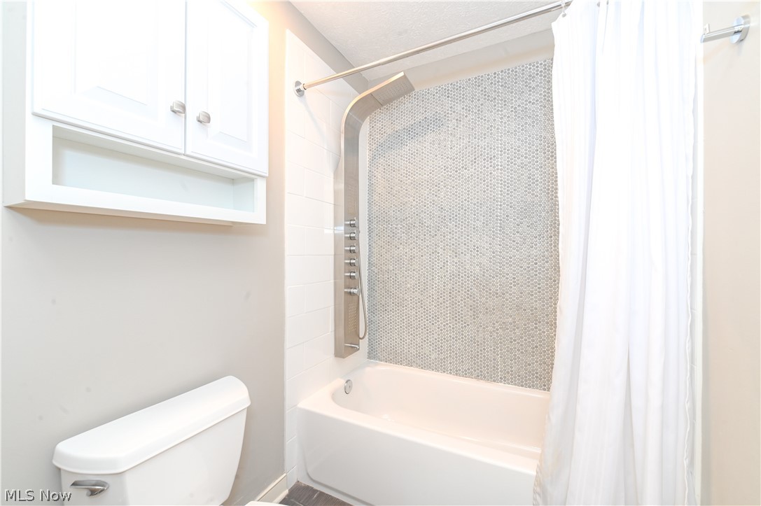 1688 Sheridan Road South Euclid, OH 44121 - Photo 28 of 48 Bathroom featuring shower / bath combination with curtain and toilet