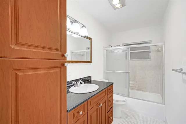 a bathroom with a sink a mirror and a shower