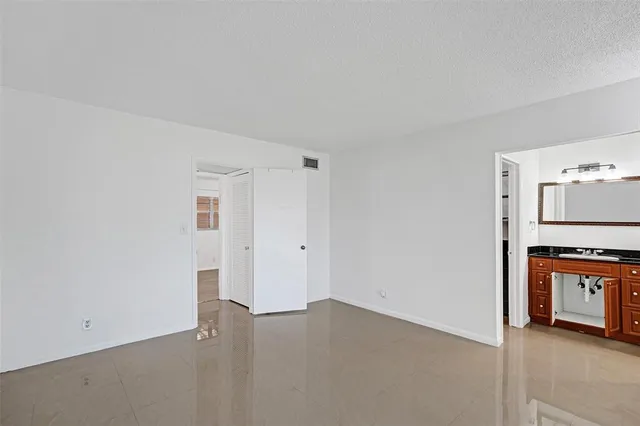a view of a kitchen with a sink a refrigerator and window