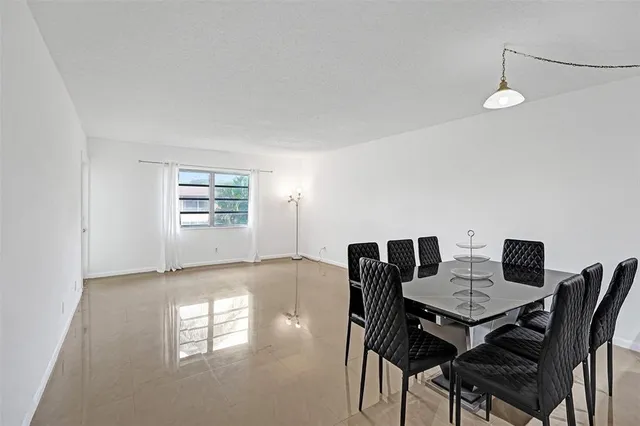 a view of a dining room with furniture and a window