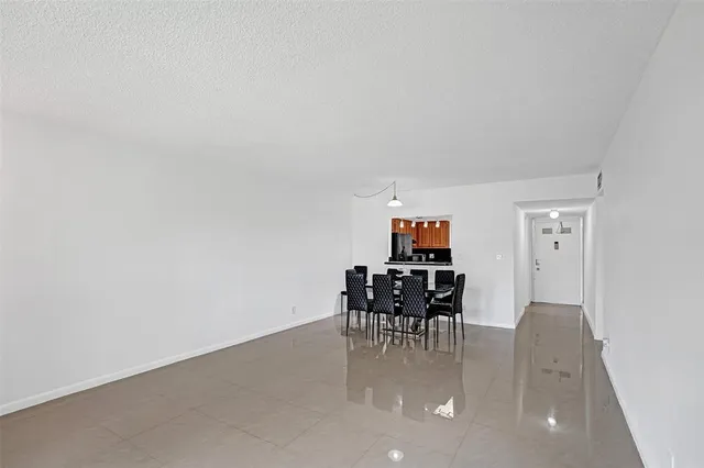 a dining room with furniture and chandelier