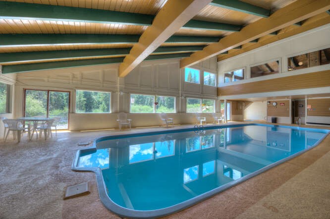 98000 Ryan Gulch Road, Unit E104 Silverthorne, CO 80498 - Photo 27 of 34 a view of a swimming pool with a patio