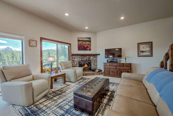 98000 Ryan Gulch Road, Unit E104 Silverthorne, CO 80498 - Photo 3 of 34 a living room with furniture a large window and a flat screen tv