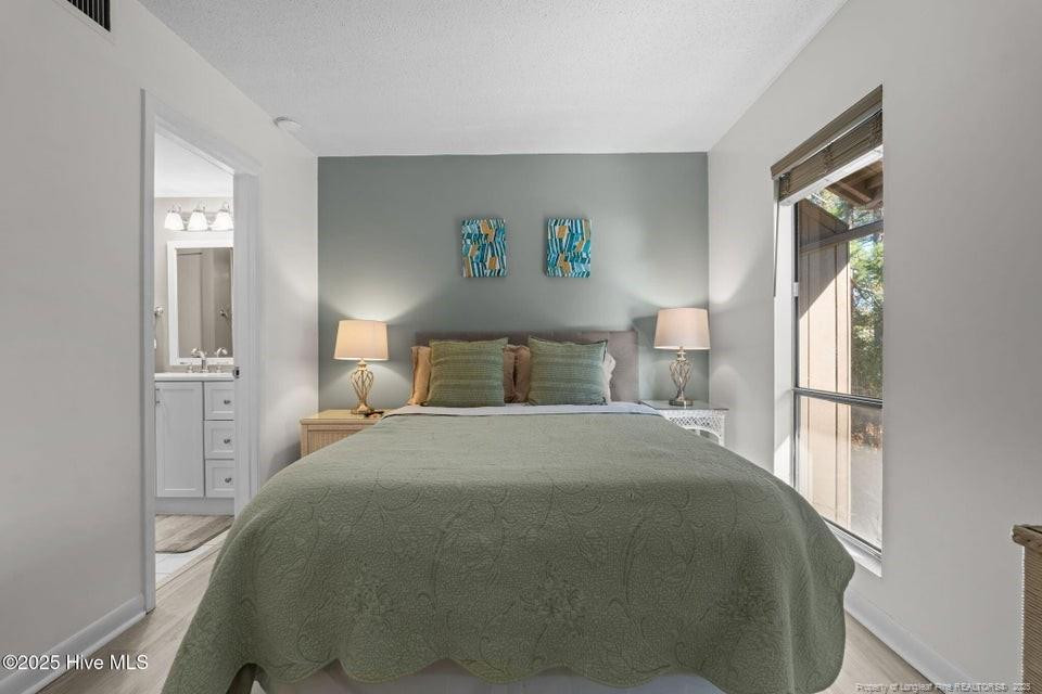 10 Pine Tree Road, Unit 211 Lakeview, NC 28350 - Photo 15 of 36 a bedroom with a bed and a window