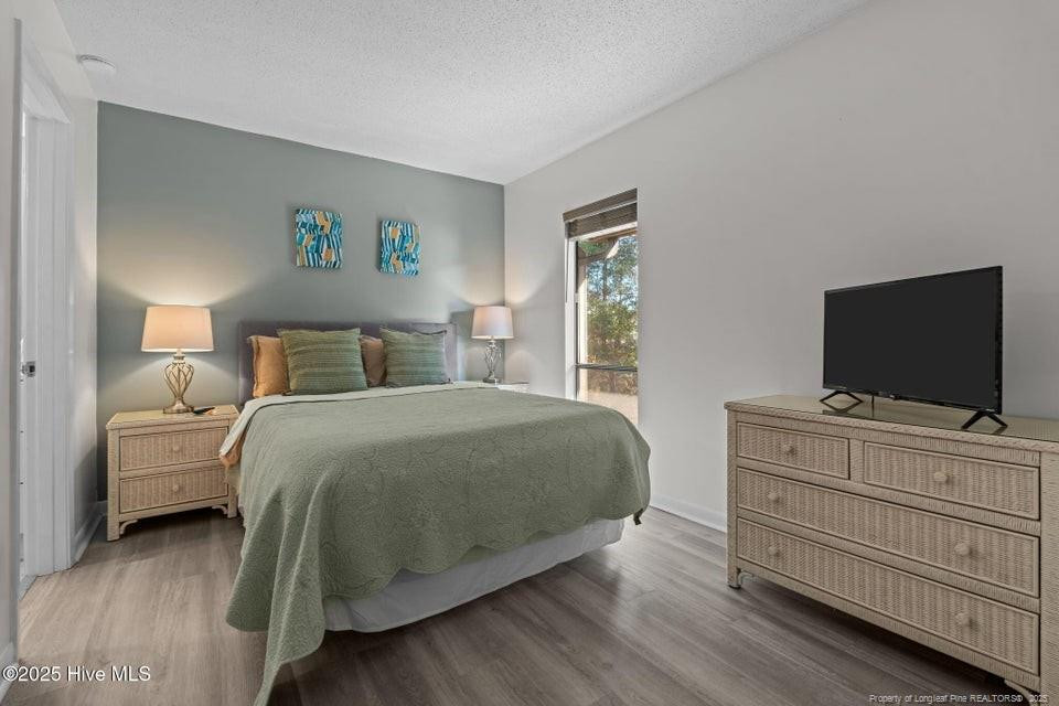 10 Pine Tree Road, Unit 211 Lakeview, NC 28350 - Photo 16 of 36 a bedroom with a bed and a flat screen tv