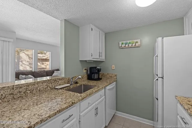 a kitchen with a sink cabinets and window