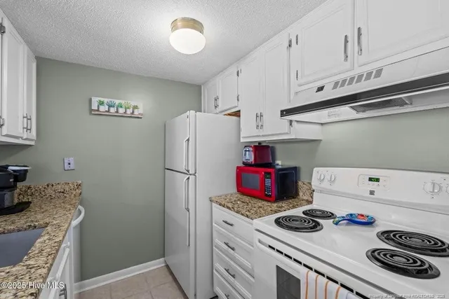 a kitchen with a stove and a refrigerator