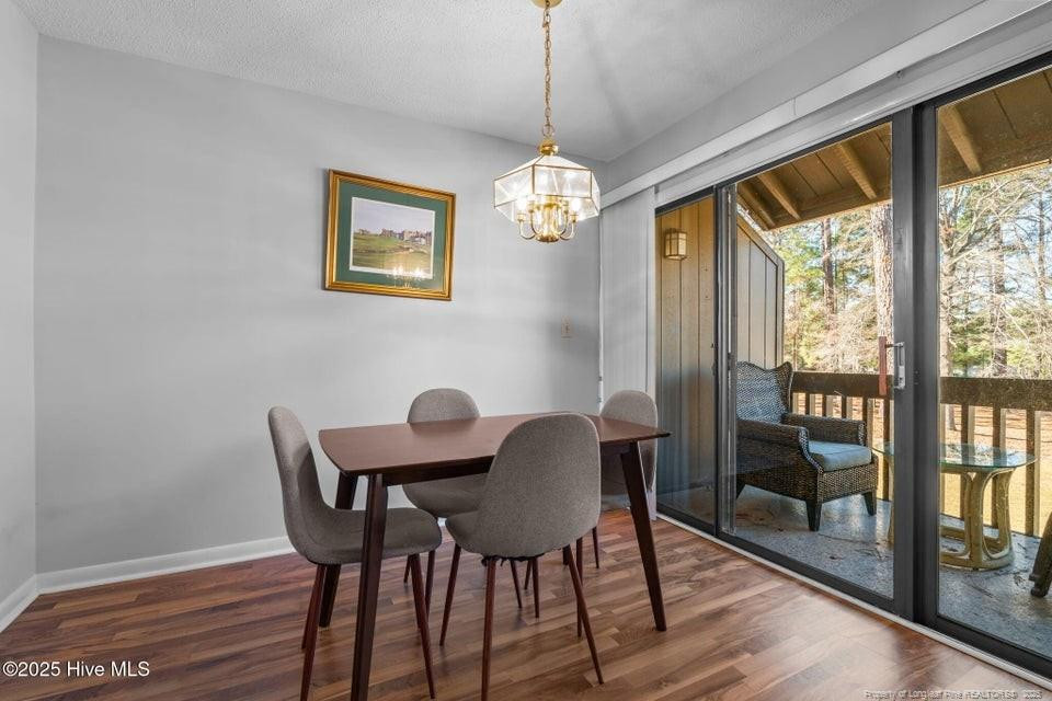 10 Pine Tree Road, Unit 211 Lakeview, NC 28350 - Photo 7 of 36 a view of a dining room with furniture window and wooden floor