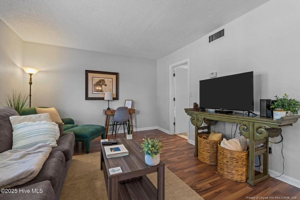 10 Pine Tree Road, Unit 211 Lakeview, NC 28350 - Photo 9 of 36 a living room with furniture and a flat screen tv