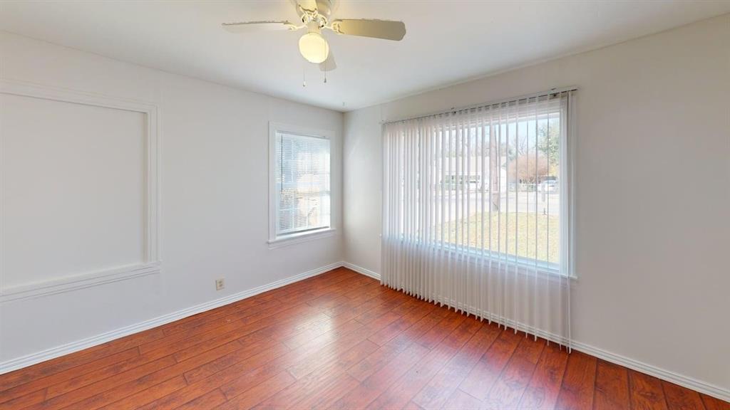 2246 Anson Road Dallas, TX 75235 - Photo 6 of 20 Bright room with wood-finish flooring, white walls, and a ceiling fan with integrated lighting