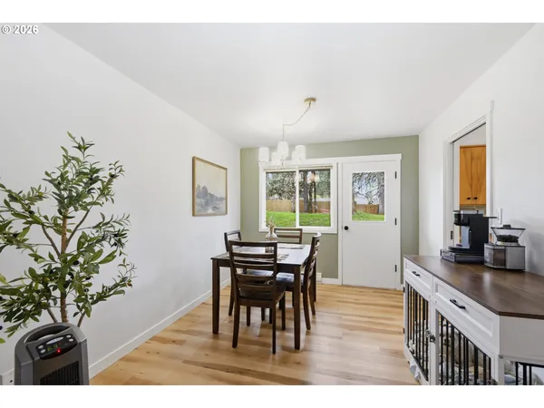 a view of a dining room with furniture and chandelier