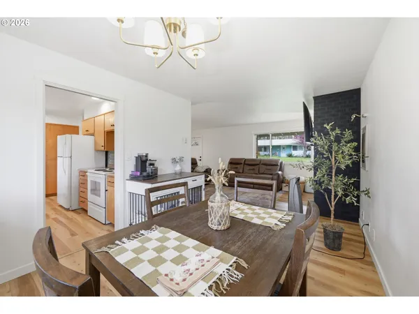 a kitchen with a refrigerator and a stove top oven