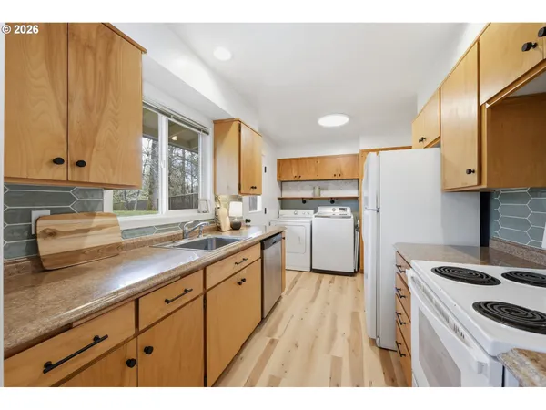 a kitchen with a sink stove and cabinets