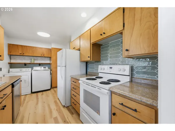 a kitchen with a stove a sink and a refrigerator