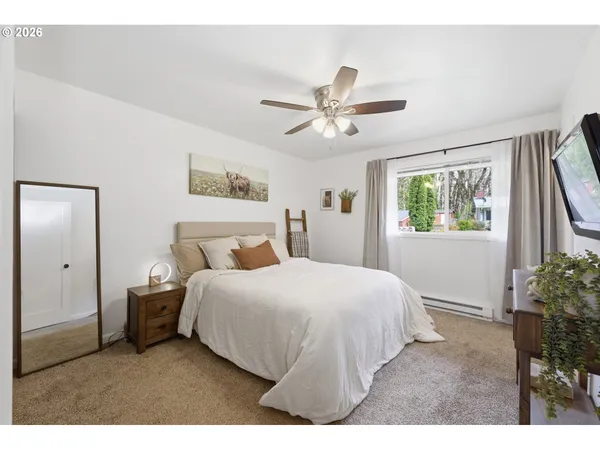 a bedroom with a large bed and a window