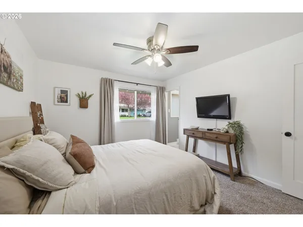 a bedroom with a bed and a flat screen tv