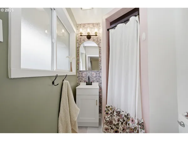 a bathroom with a bathtub and a mirror