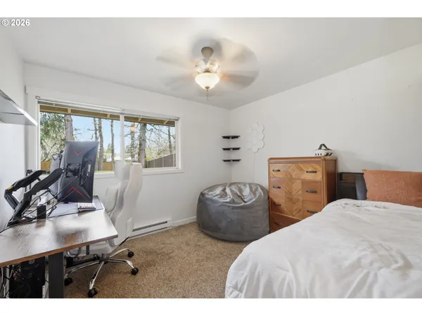 a bedroom with two beds and a desk