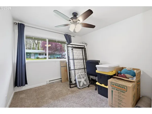 a room with furniture and ceiling fan