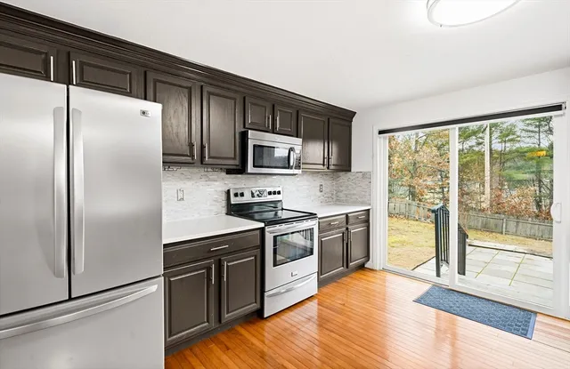 a kitchen with stainless steel appliances granite countertop a refrigerator stove and sink