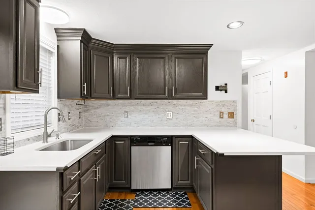 a kitchen with a sink stove and cabinets