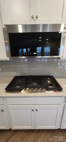 a stove top oven sitting inside of a kitchen