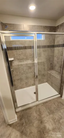 a bathroom with a glass door shower
